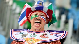 Ein thailändischer Fan singt auf der Tribüne. © DPA Picture Alliance Foto: Kay Nietfeld
