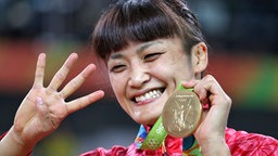 Die japanische Ringerin Kaori Icho freut sich über Olympisches Gold. © dpa Foto: Sergei Ilnitsky