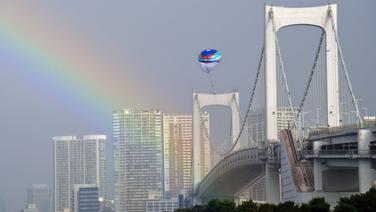 Impressionen aus der Olympiastadt Tokio mit einem Heißluftballon und einem Regenbogen über der Rainbow Bridge. © dpa-Bildfunk 