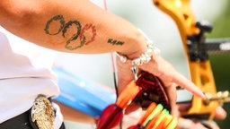 Die türkische Bogenschützin Yasemin Ecem Anagoz hat ein Tattoo mit den Olympischen Ringen auf ihrem rechten Unterarm. © picture alliance / AA | Elif Ozturk Ozgoncu