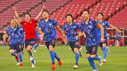 Japans Fußballer bejubeln den Sieg gegen Neuseeland. © picture alliance / ASSOCIATED PRESS | Keita Iijima 