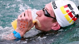 Freiwasserschwimmer Florian Wellbrock nimmt während eines Rennens Verpflegung auf. © picture alliance Foto: Laci Perenyi