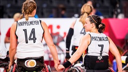 Die deutschen Rollstuhlbasketballerinnen Lena Knippelmeyer (l.) und Anne Patzwald halten mit Tränen in den Augen Händchen. © IMAGO / Beautiful Sports